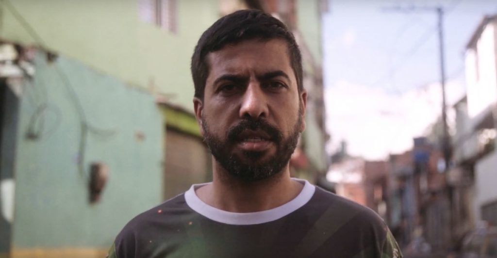 Marcio stands in a street in Sao Paolo