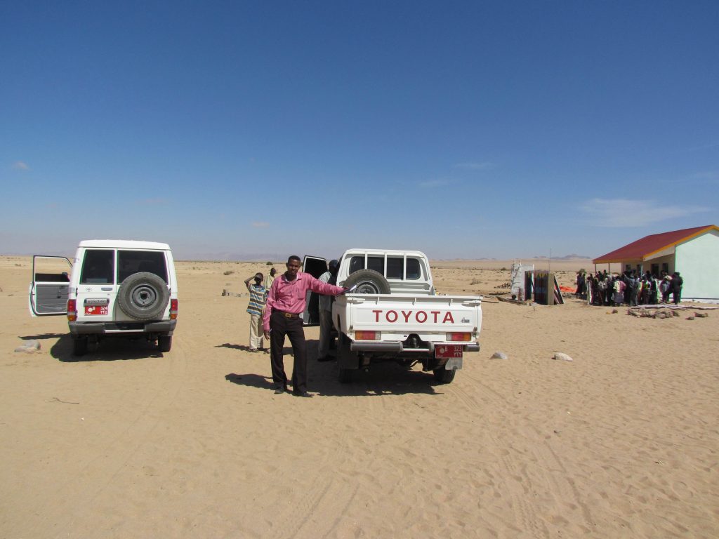 Photo of pick up truck next to a remote healthcare facility